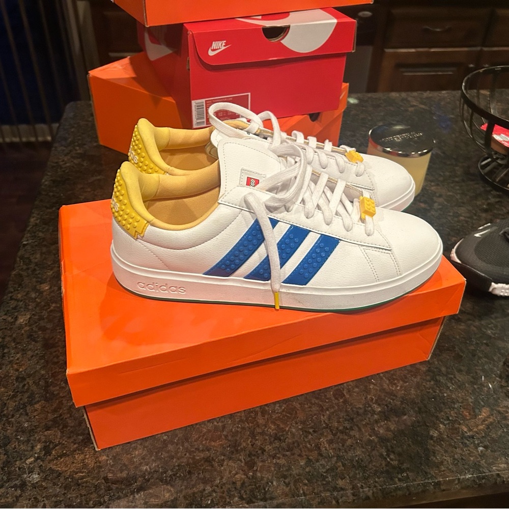 Adidas White Sneakers with Blue Stripes and Yellow Accents.  Worn a few Times.